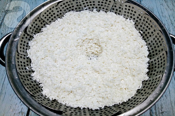 Gạo nếp đã ngâm được trộn muối và cho vào xửng hấp, khởi đầu cho cách nấu xôi trắng ngon bằng phương pháp truyền thống.