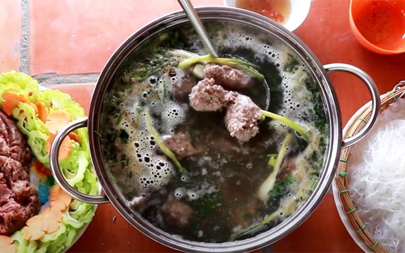Nồi nước dùng lẩu bồ câu đang sôi và các viên thịt chim