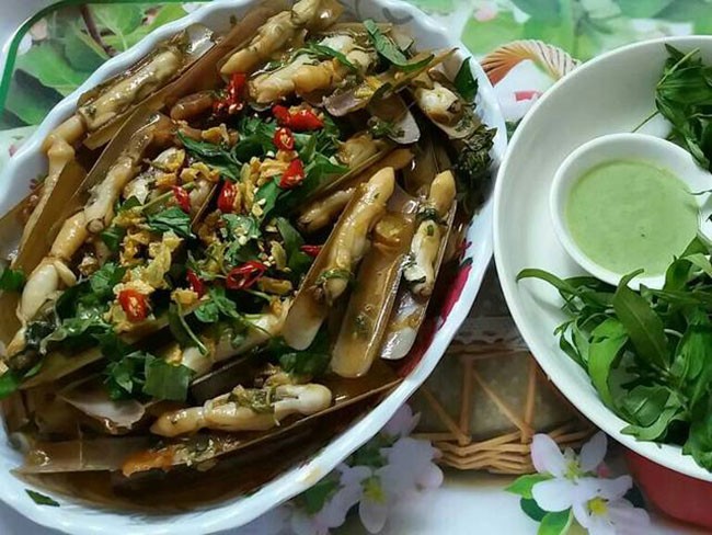 Đĩa ốc móng tay xào me đã hoàn thành, trang trí rau răm và ớt