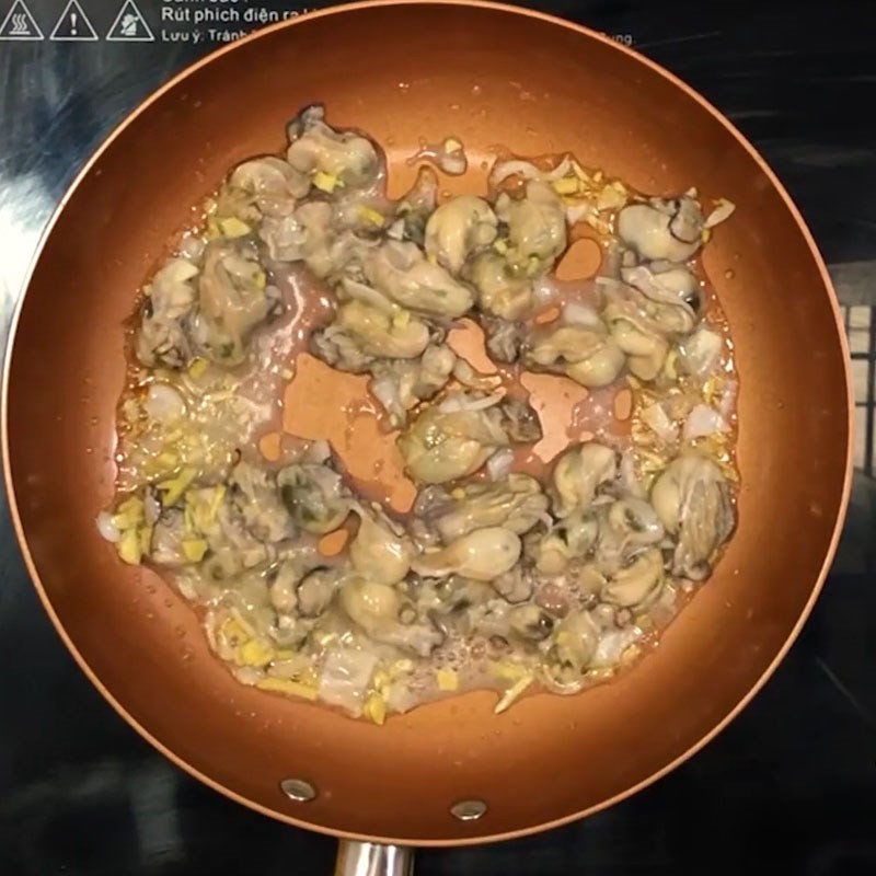 Cho thịt hàu đã ướp vào chảo, xào nhanh trên lửa lớn