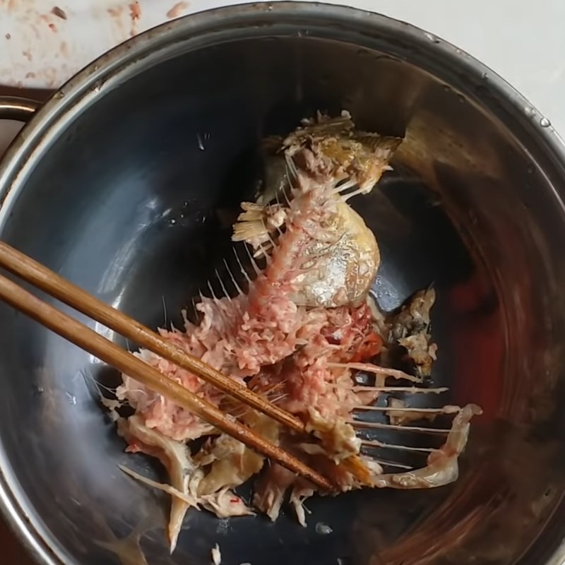 Giã nhuyễn xương cá chép để lấy nước dùng