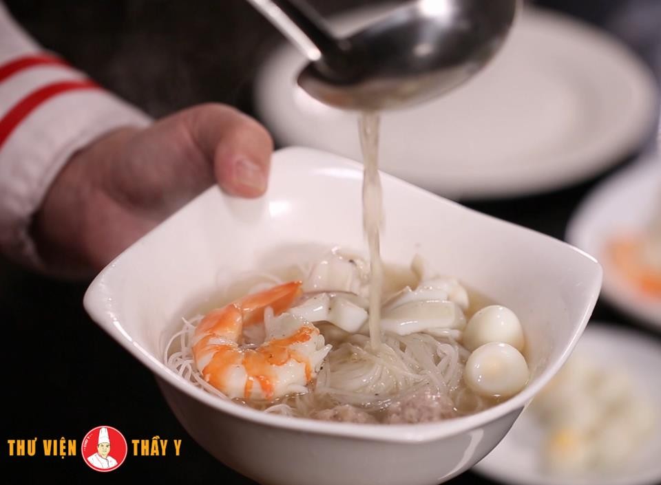 Một tô hủ tiếu mực ngon hấp dẫn với đầy đủ topping, hành lá và ngò rí tươi xanh.