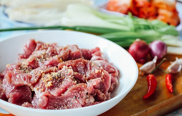 Ướp thịt bò thái mỏng chuẩn bị cho món canh kim chi thịt bò