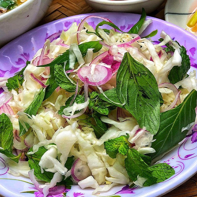 Gỏi bắp cải trộn đều với rau thơm và nước sốt chua ngọt
