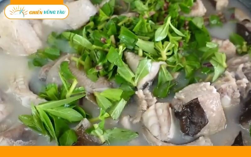 Bàn ăn với lẩu cá đuối nóng hổi, bún và rau sống tươi ngon