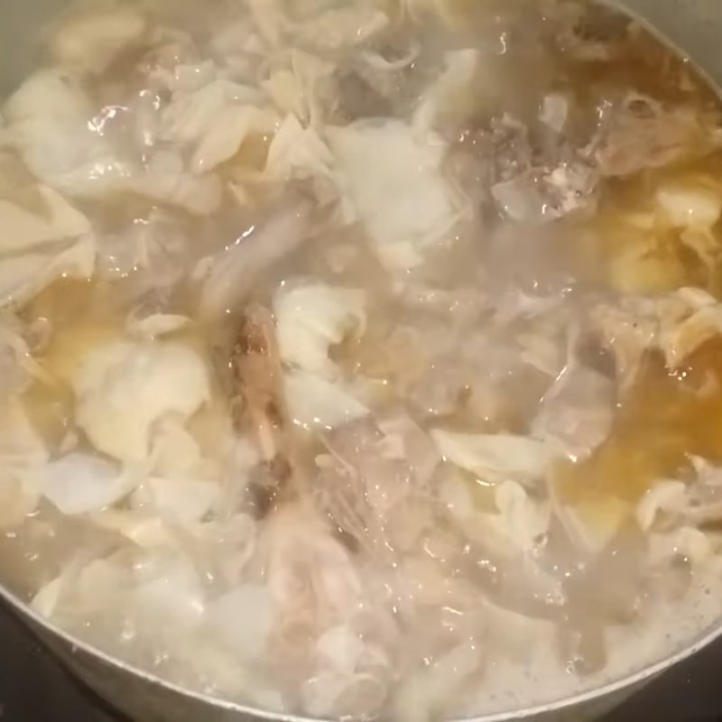 Đổ nước vào nồi sau khi xào vịt và măng, chuẩn bị cho quá trình nấu canh vịt măng chua
