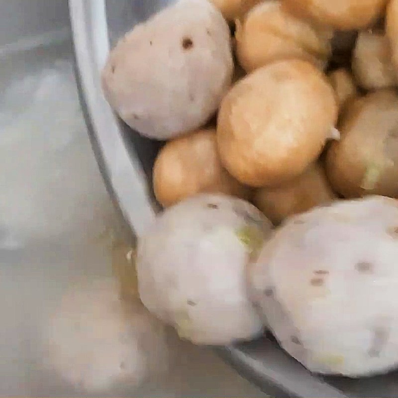 Thêm chả cá hấp và nấm rơm xào vào nồi cháo đang sôi