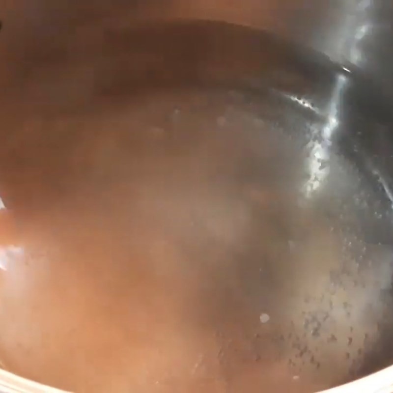 Nồi nước canh chua cá lăng với măng và khế đang sôi