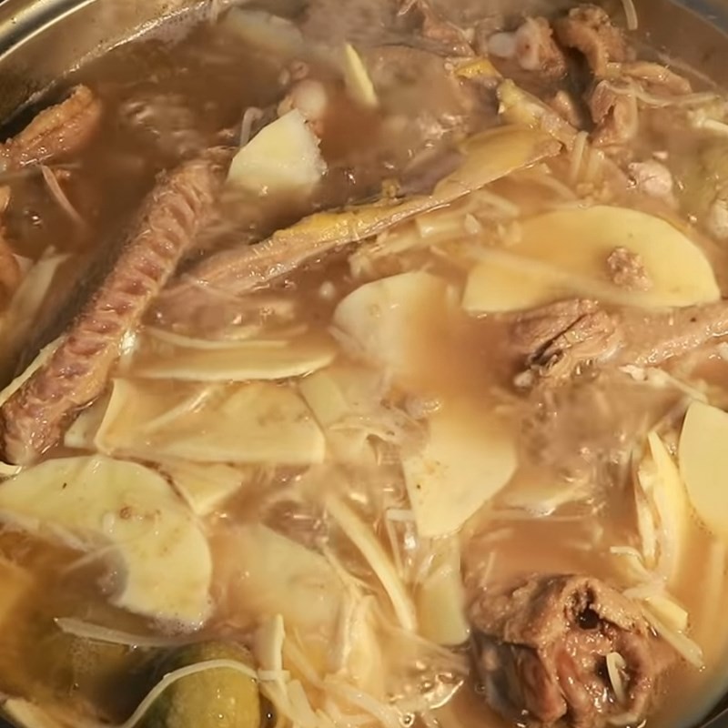 Thêm măng tươi vào nồi vịt om sấu, hòa quyện các hương vị trong món vịt om măng
