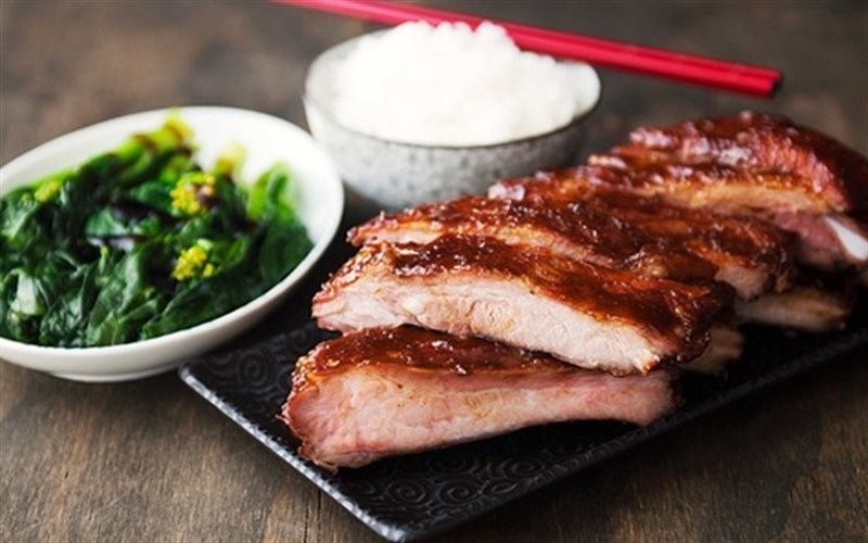 Những miếng sườn cốt lết vàng ươm, thơm phức đang được nướng trên bếp than hồng