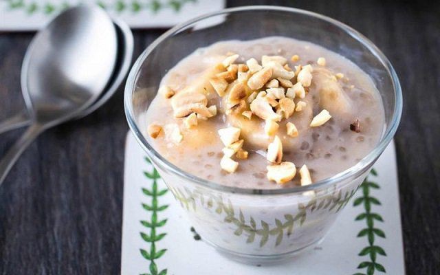 Bát chè chuối bột báng đã hoàn thành, rắc dừa nạo và đậu phộng rang
