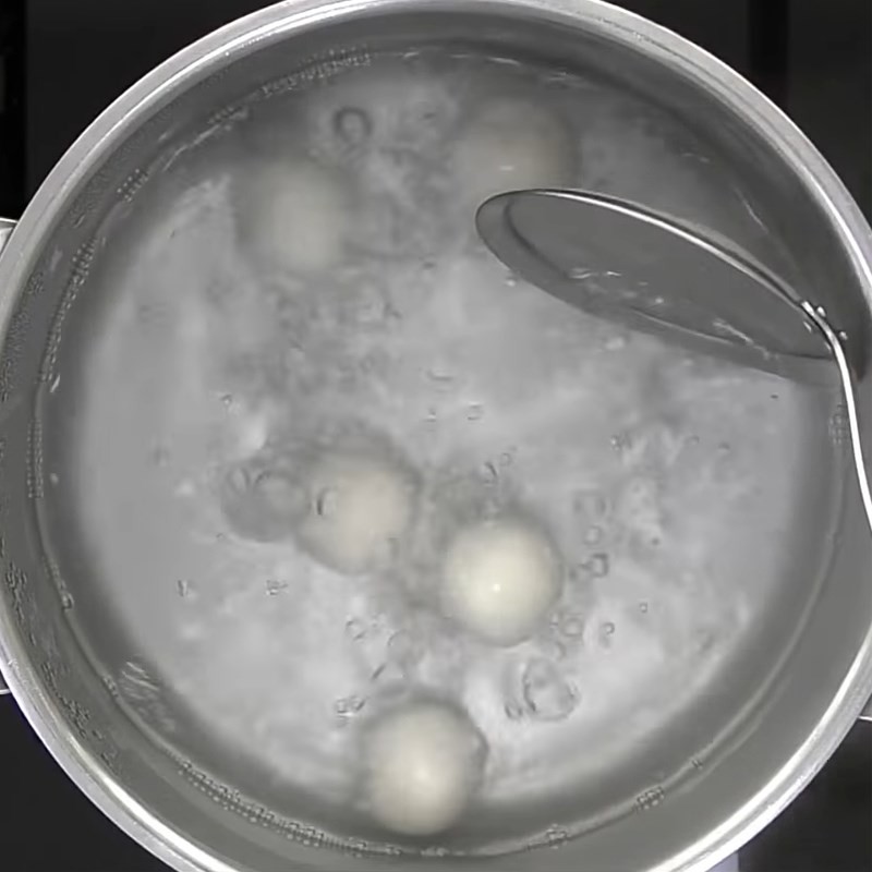 Kỹ thuật khéo léo túm kín mép bột, đảm bảo nhân đậu phộng được bao bọc hoàn toàn bên trong viên chè trôi nước.