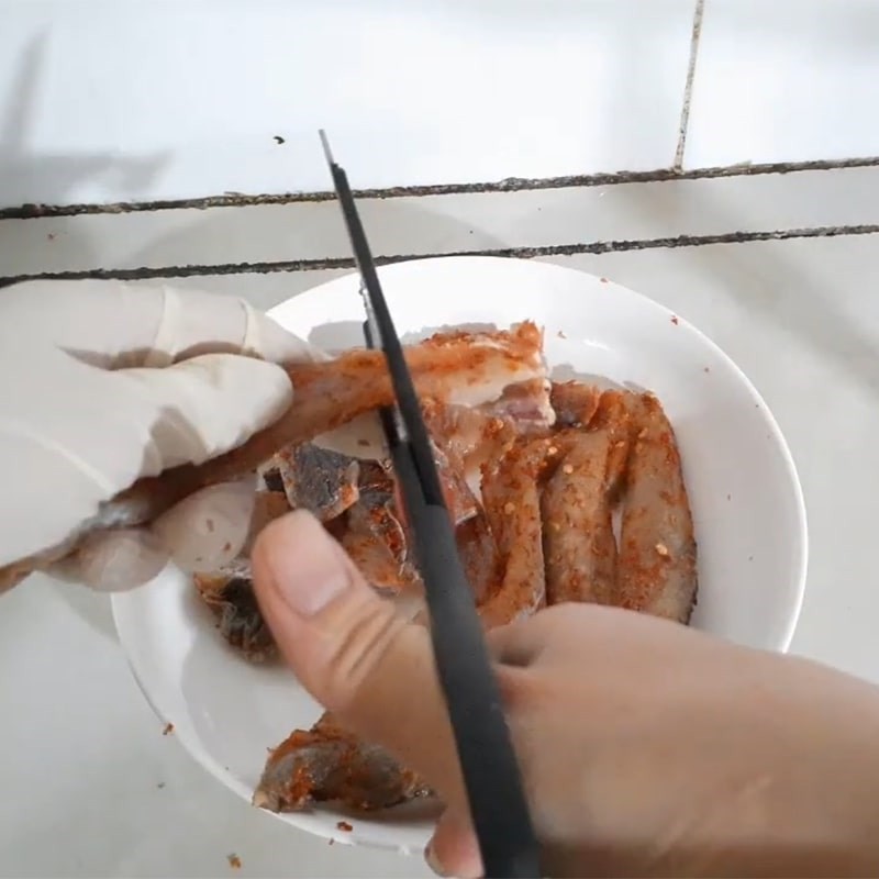 Sơ chế khô cá lóc bằng cách cắt miếng vừa ăn