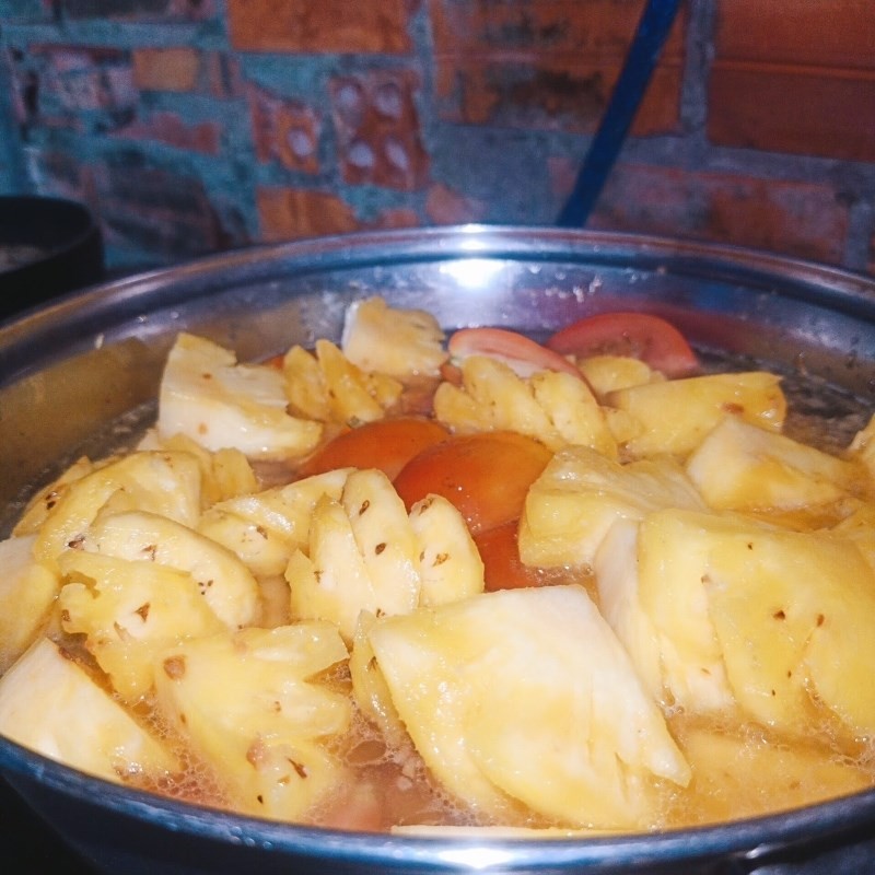 Nước sốt cà chua và thơm đang sôi, sẵn sàng cho cá ngừ vào kho