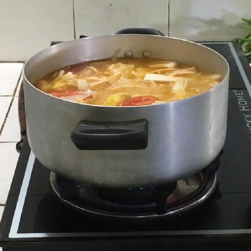 Cho cá lóc đã sơ chế vào nồi lẩu đang sôi