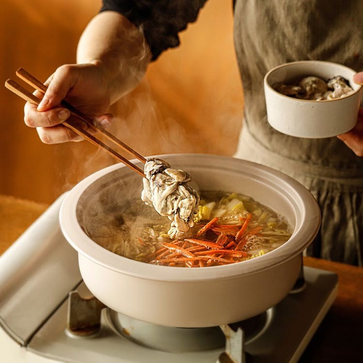 Thêm tỏi băm, cà rốt và những con hàu tươi ngon vào nồi canh cải thảo