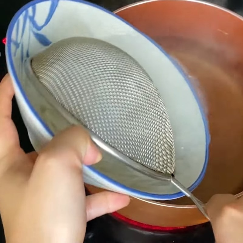 Trụng sợi hủ tiếu để chuẩn bị món hủ tiếu xí quách