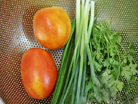 Rửa sạch rau mùi để làm món canh cà chua trứng trong cách nấu món ăn hàng ngày